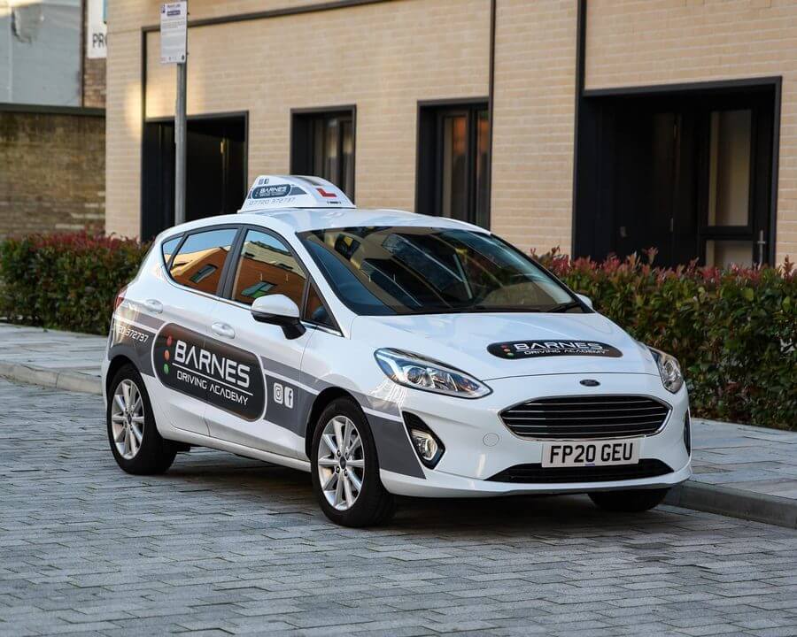 Driving school roof sign and matching vehicle branding for Barnes Driving Academy.